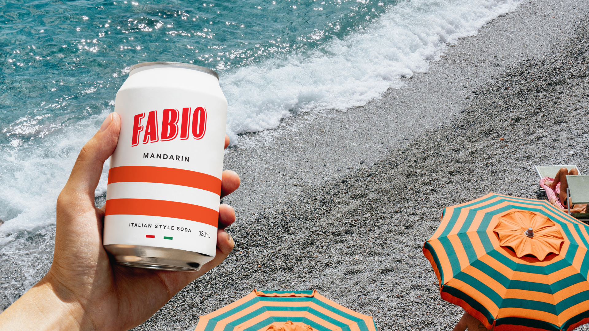 Fabio Mandarino on a beach with umbrellas in the background